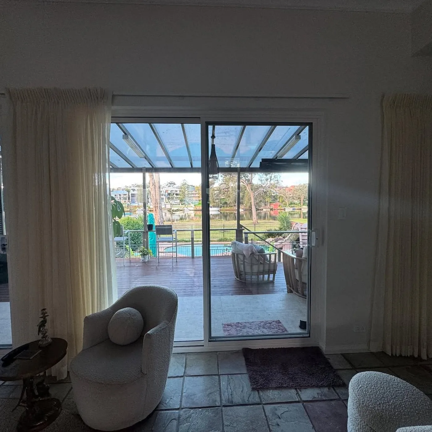 Aluminium sliding door opening a living room onto a covered outdoor terrace - AGM Windows & Doors, Sydney