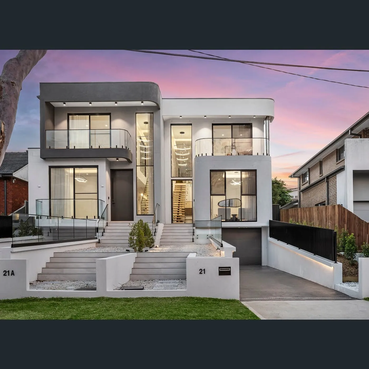Pair of modern duplex homes at dusk with full height aluminium window glazing - AGM Windows & Doors, Sydney