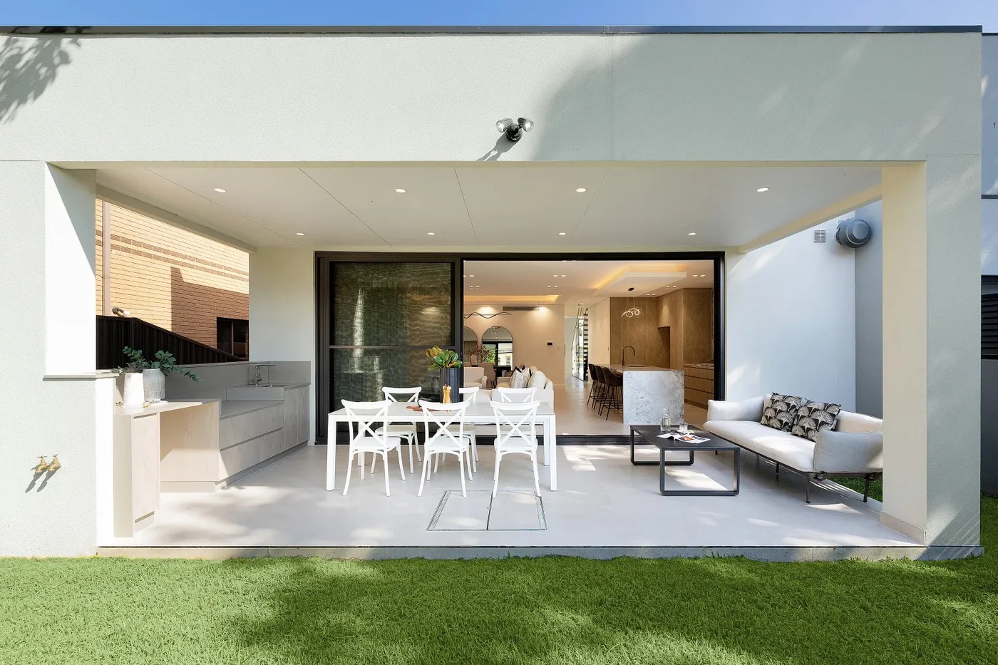 Aluminium glazing framing an open-plan living and dining space in a Sydney home