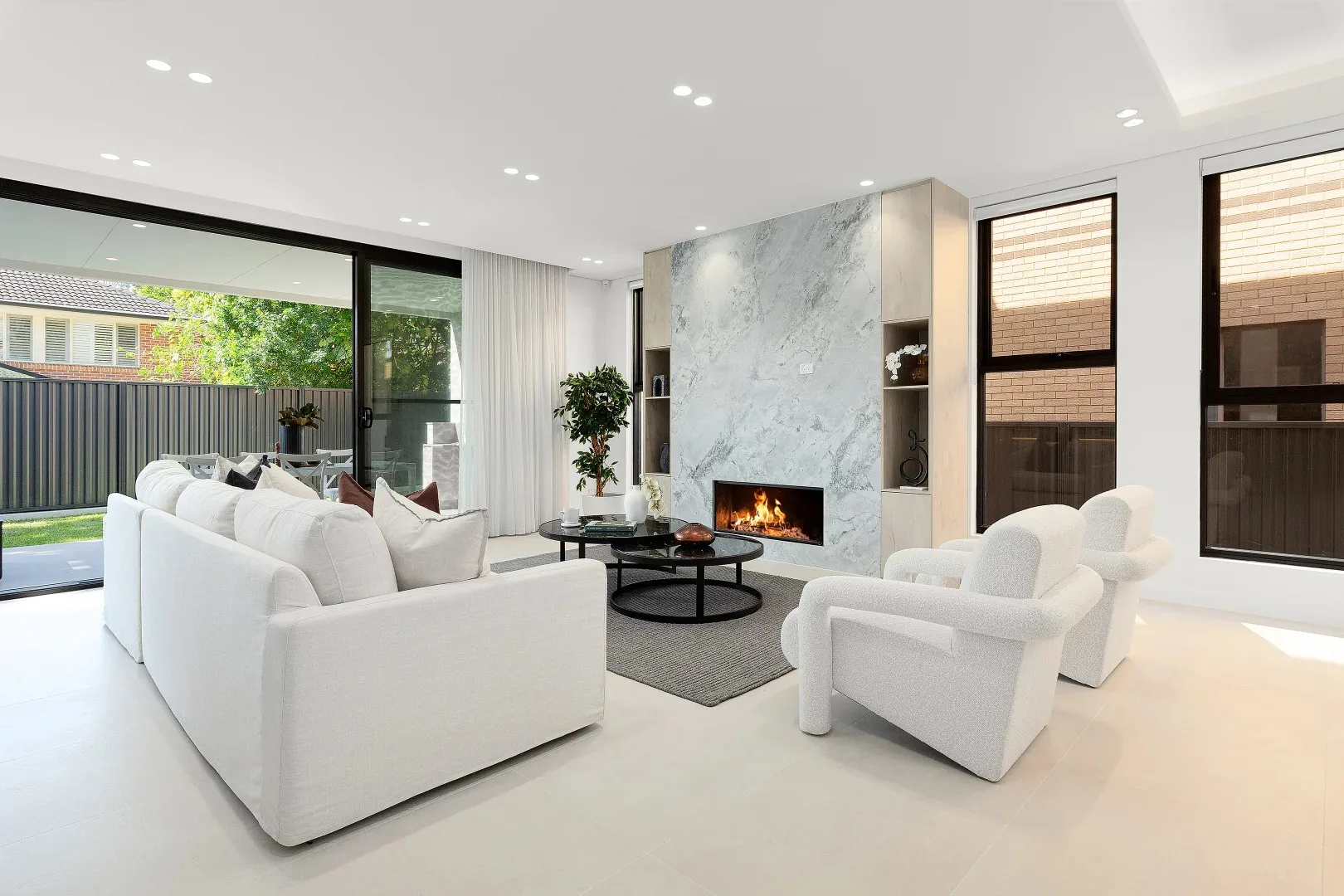 Wide aluminium sliding doors framing a bright open living area - AGM Windows & Doors, Sydney