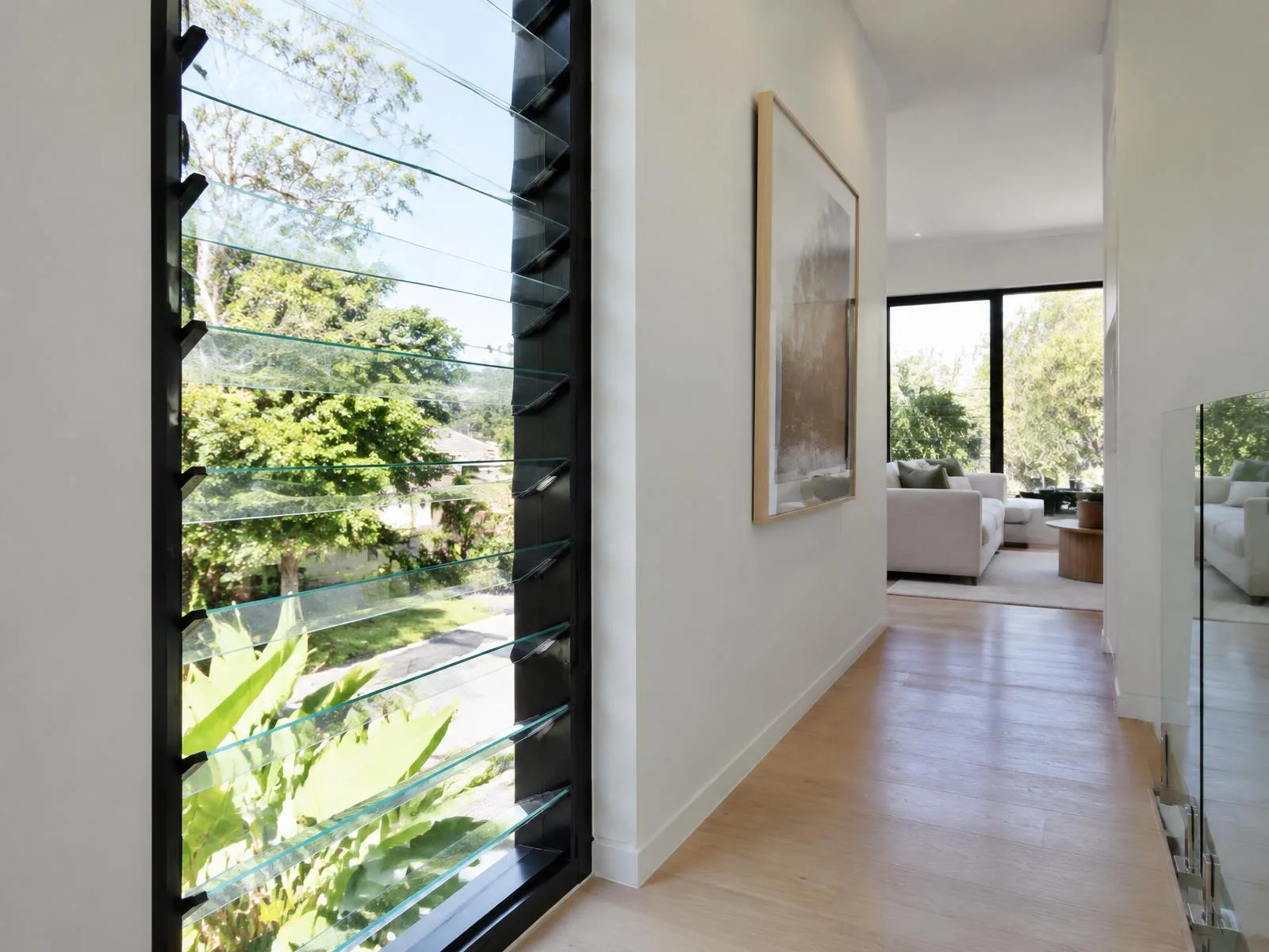 Illustrative image of glass louvre windows with black aluminium frames in a Sydney home