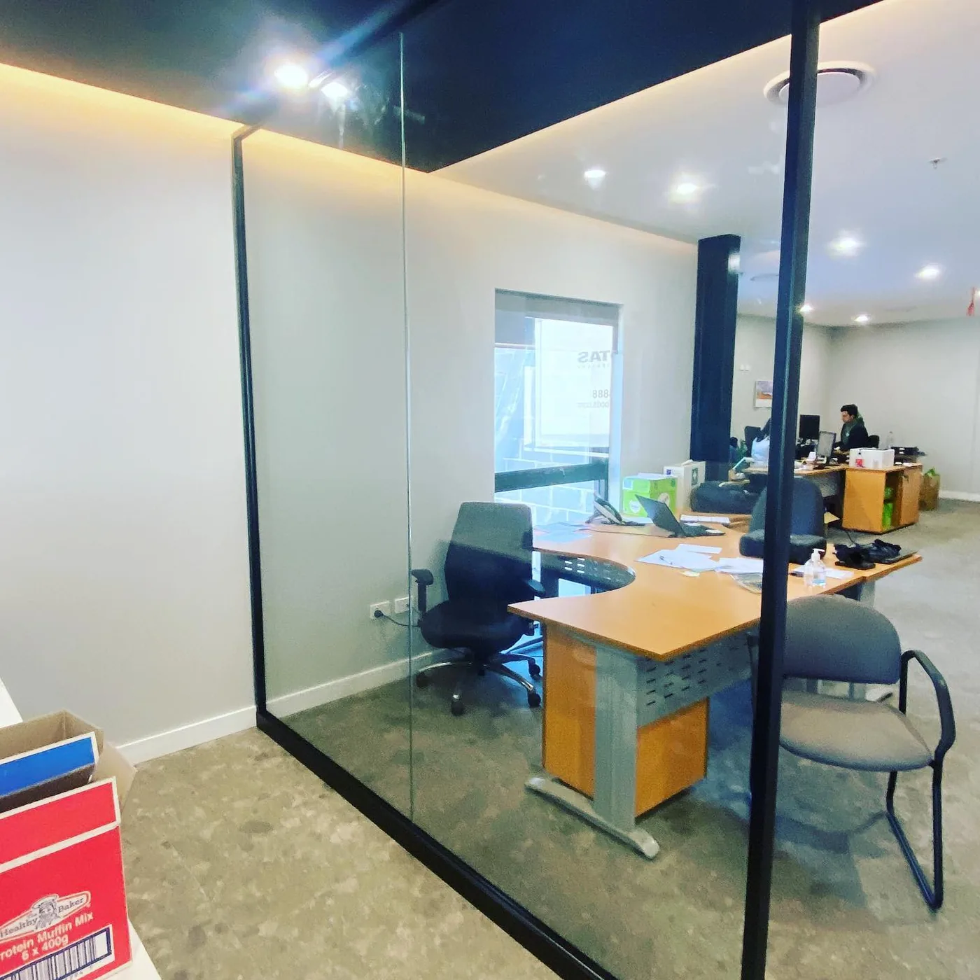 Frameless glass office partition installed in a Sydney workplace